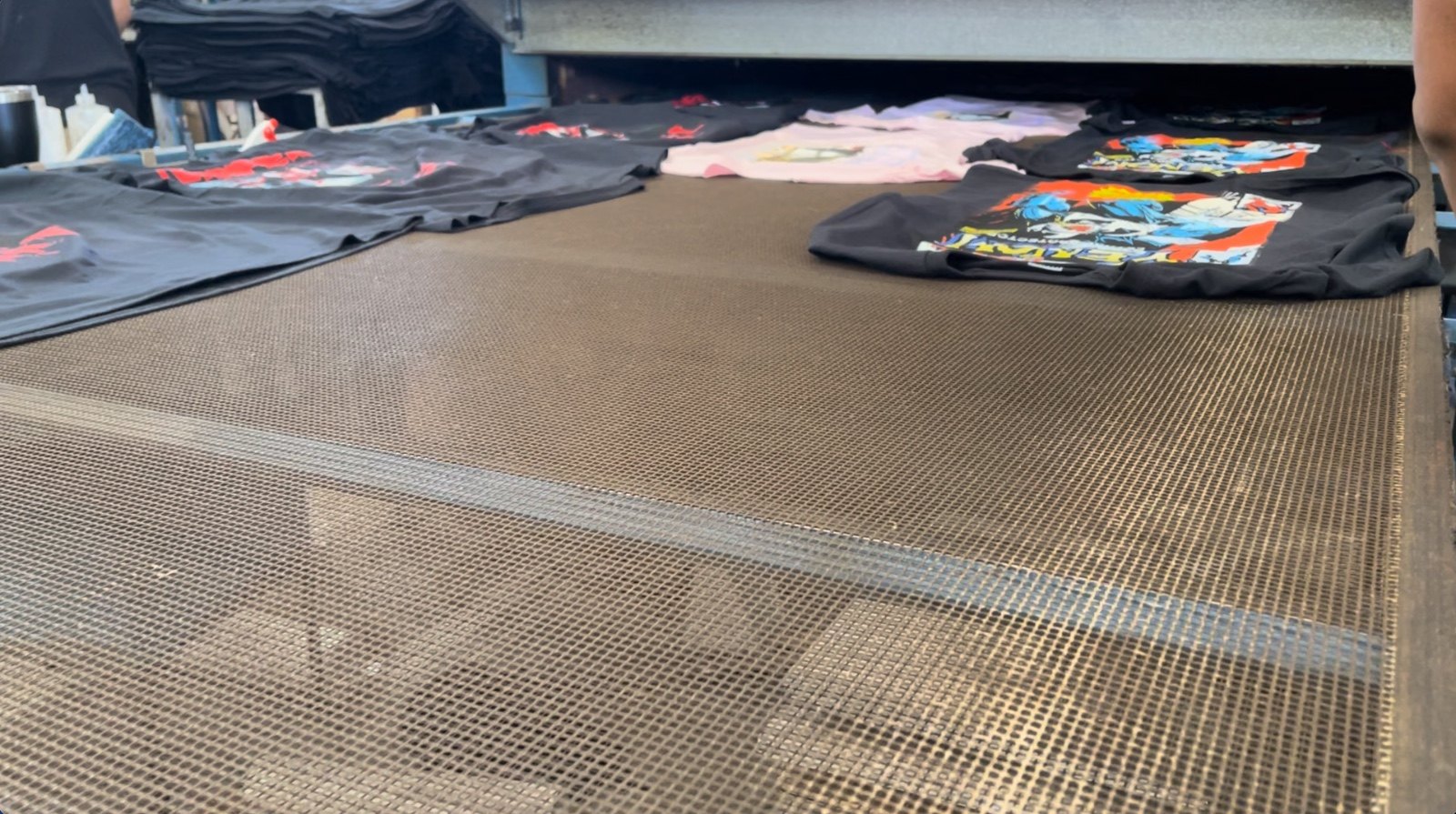 Printed shirts on the drying conveyor belt