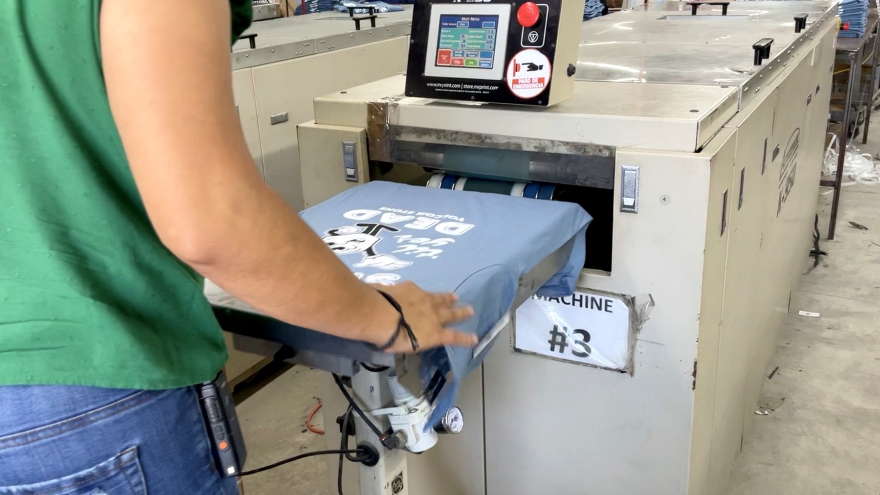 Heat press machine finishing a printed shirt